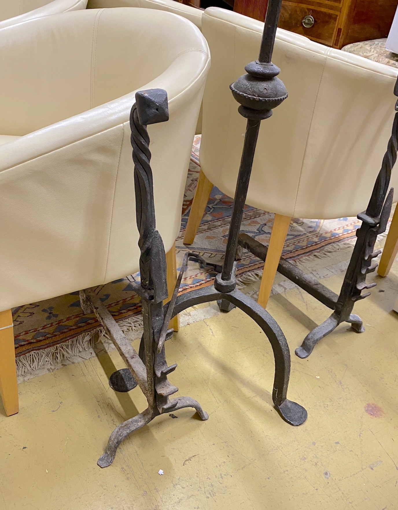 A wrought iron tripod pricket candlestick, height 138cm, together with a pair of andirons and a snuffer